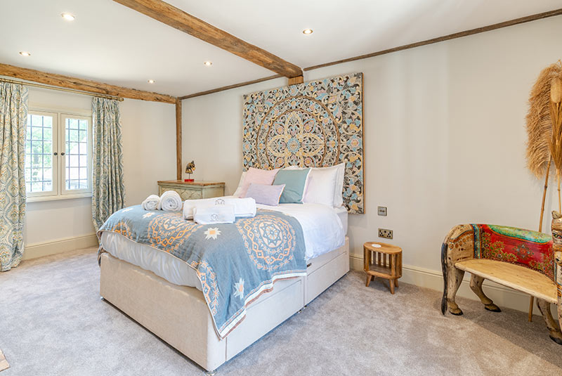 Luxury bedroom in the main house at Porters Hall featuring a four-poster bed and high-quality white linens.