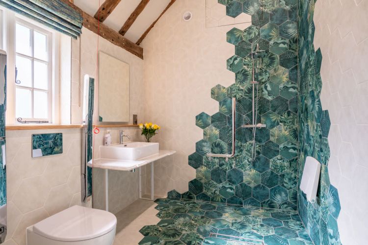 Traditional bathroom at Porters Hall featuring a freestanding romantic copper bathtub and modern en-suite fixtures.