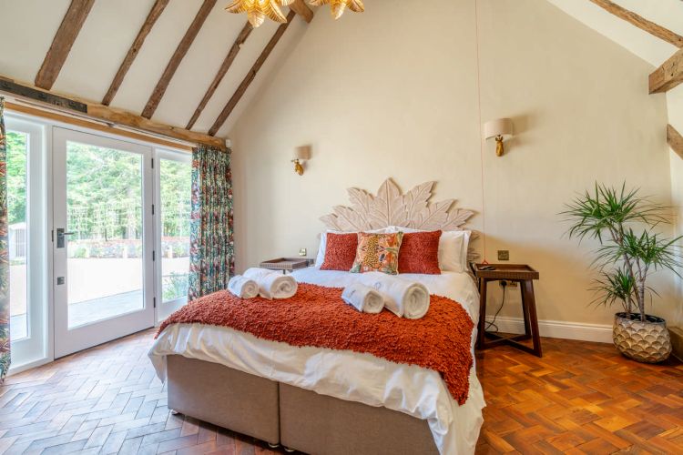 Luxury bedroom in the main house at Porters Hall featuring a four-poster bed and high-quality white linens.