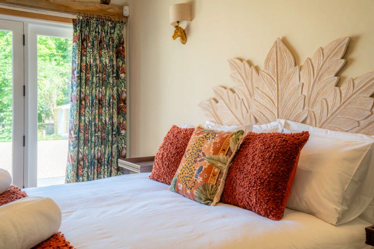 Luxury bedroom in the main house at Porters Hall featuring a four-poster bed and high-quality white linens.