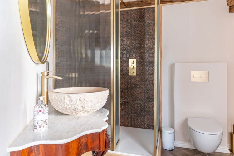 Traditional bathroom at Porters Hall featuring a freestanding romantic copper bathtub and modern en-suite fixtures.