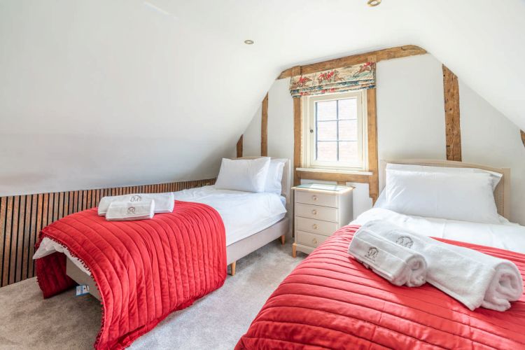 Luxury bedroom in the main house at Porters Hall featuring a four-poster bed and high-quality white linens.