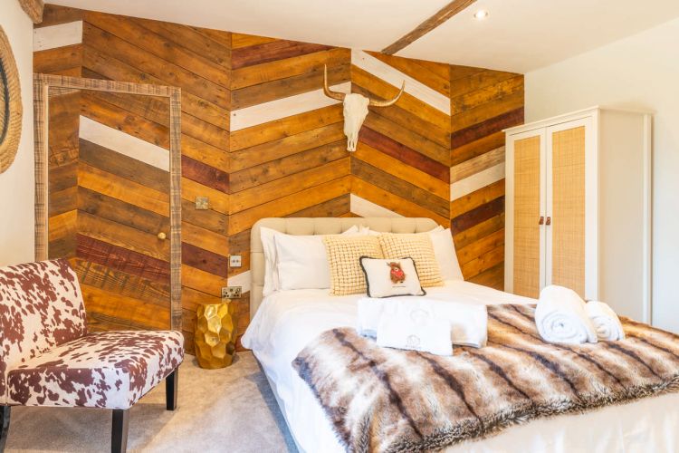 Luxury bedroom in the main house at Porters Hall featuring a four-poster bed and high-quality white linens.