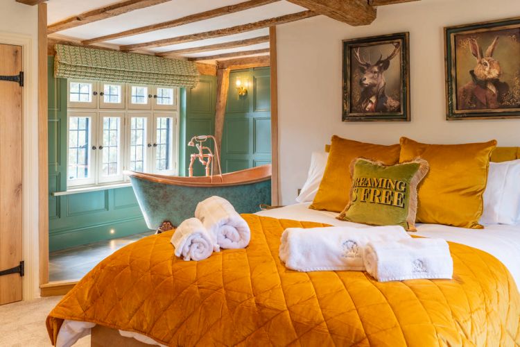 Luxury bedroom in the main house at Porters Hall featuring a four-poster bed and high-quality white linens.
