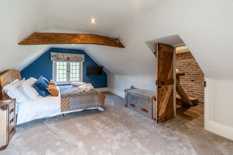 Luxury bedroom in the main house at Porters Hall featuring a four-poster bed and high-quality white linens.