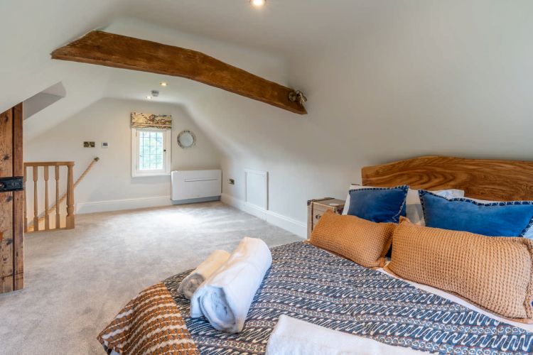 Luxury bedroom in the main house at Porters Hall featuring a four-poster bed and high-quality white linens.